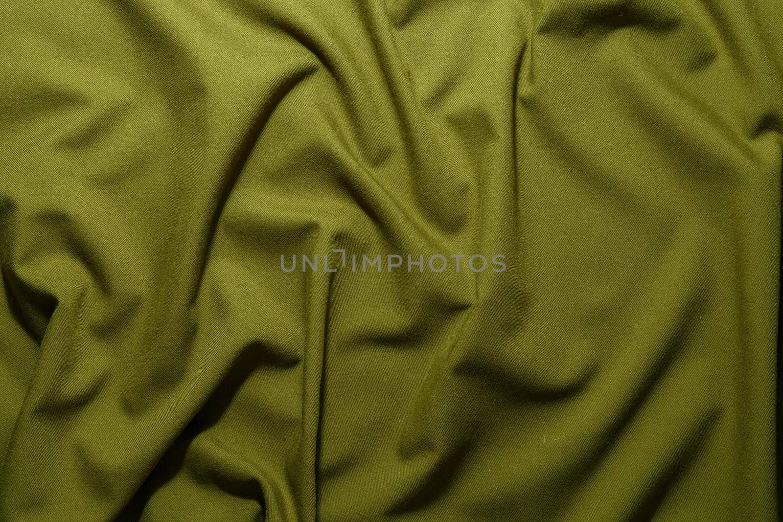 crumpled olive greencrumpled tan khaki canvas fabric - full frame background and texture.