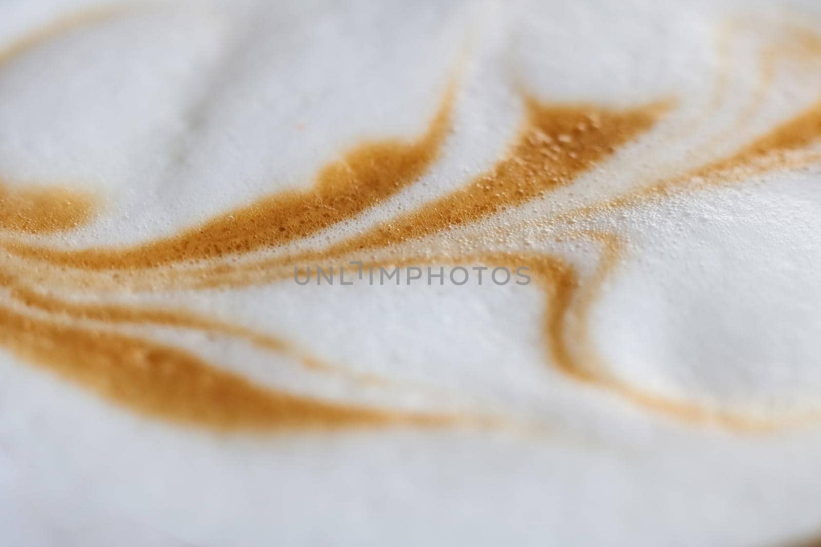Drawing on white crema from coffee close up, macro photo