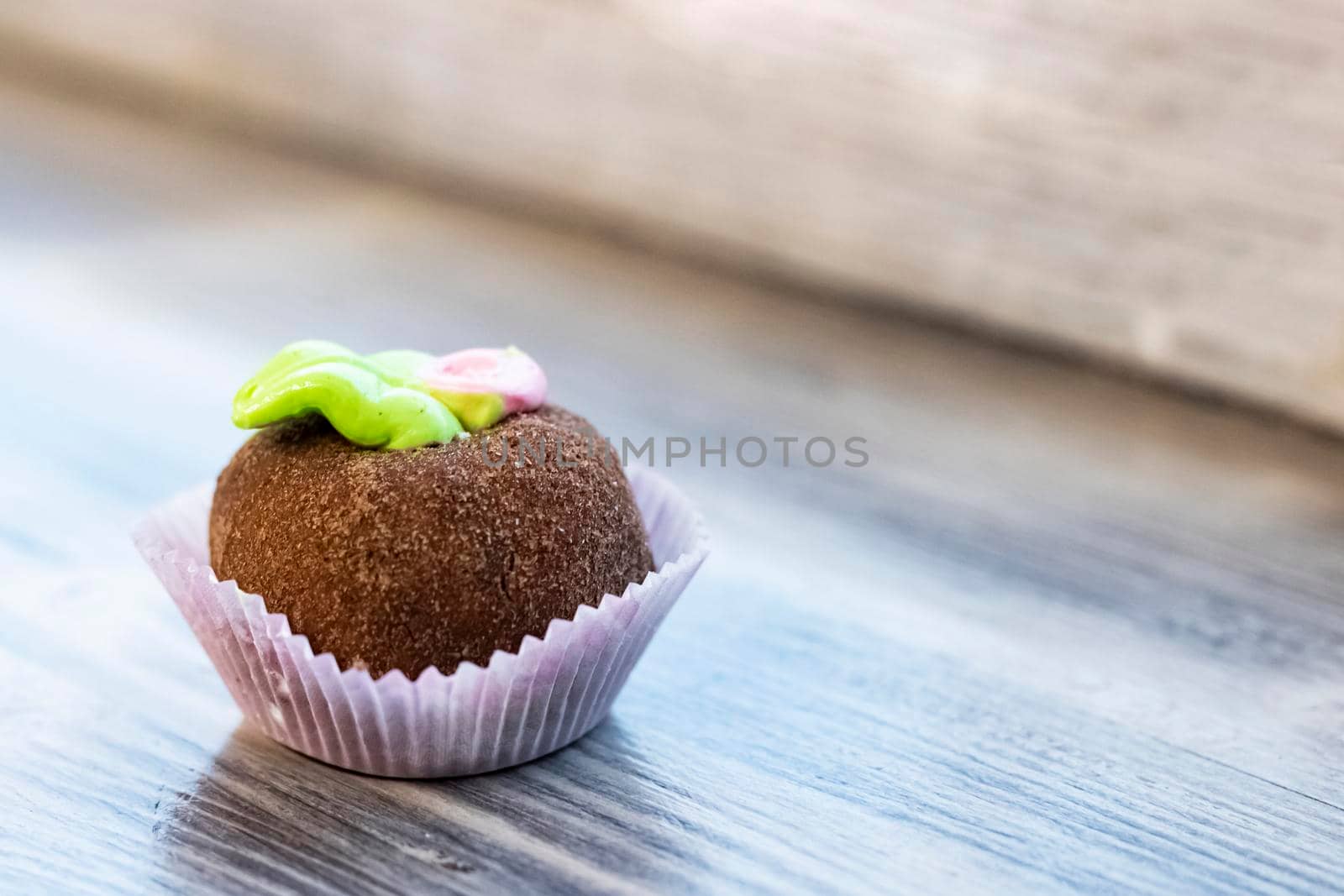 Round chocolate cake on a wooden table, copy space