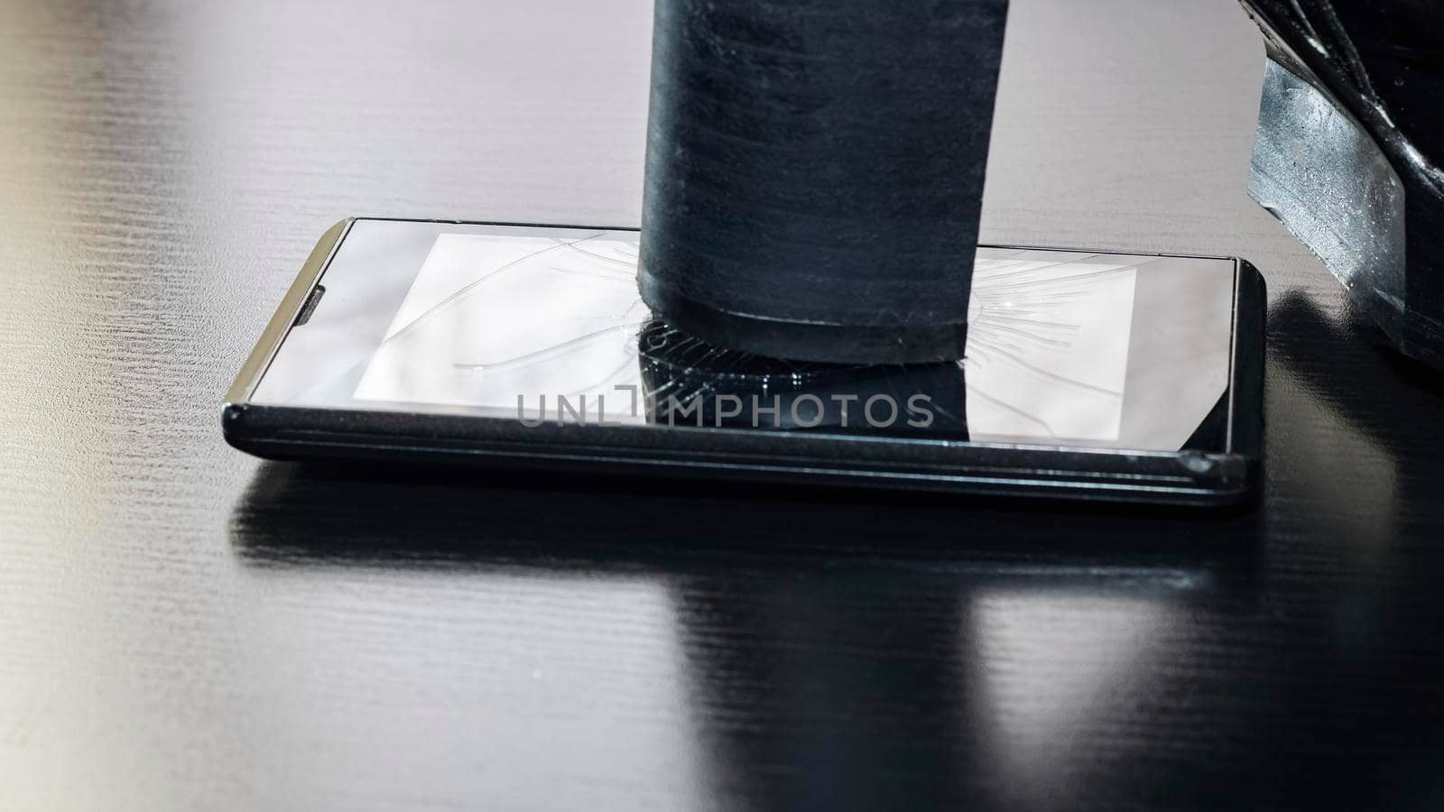 Broken screen telephone with heel shoes close up