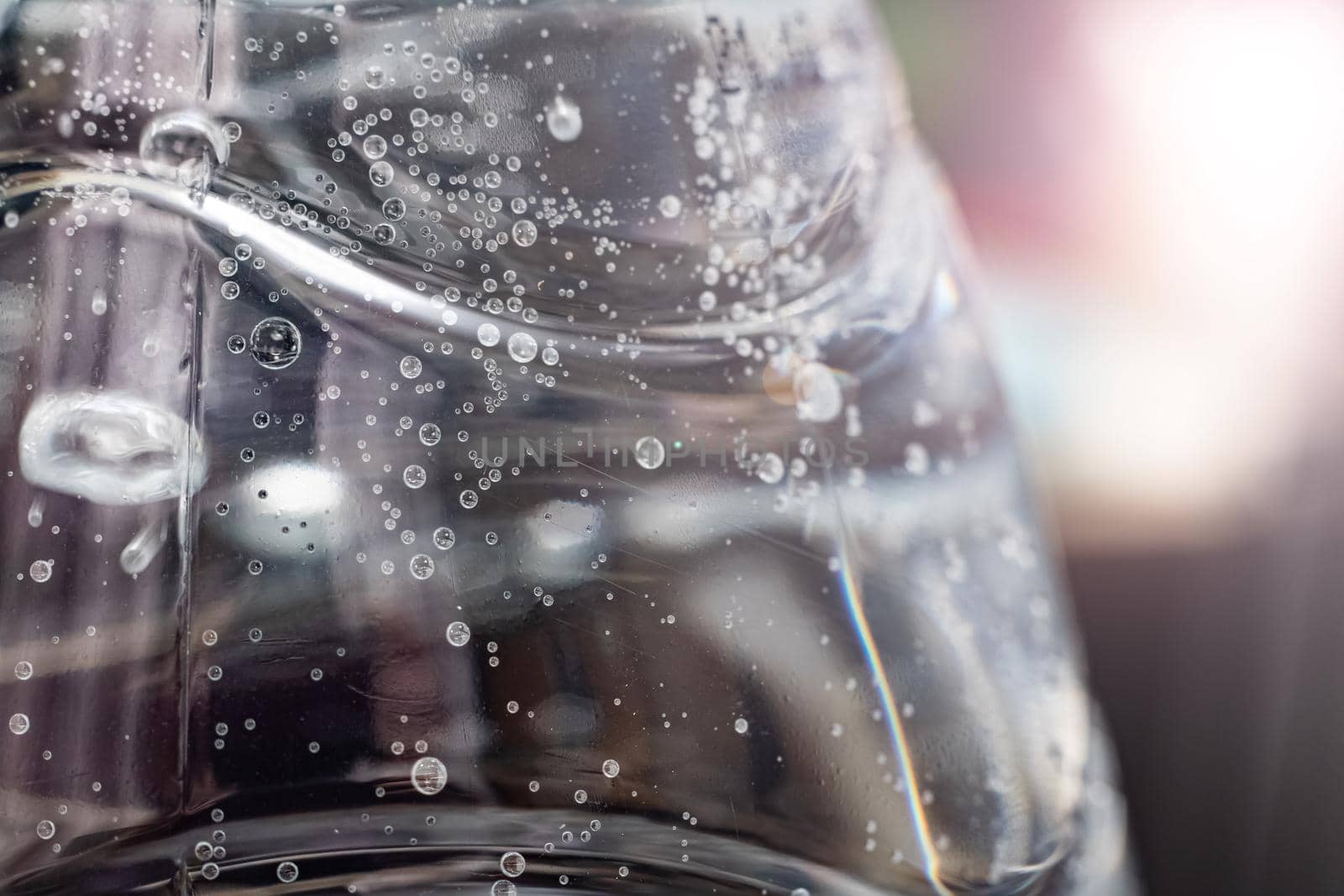 Bubbles in a water bottle in sunlight close up