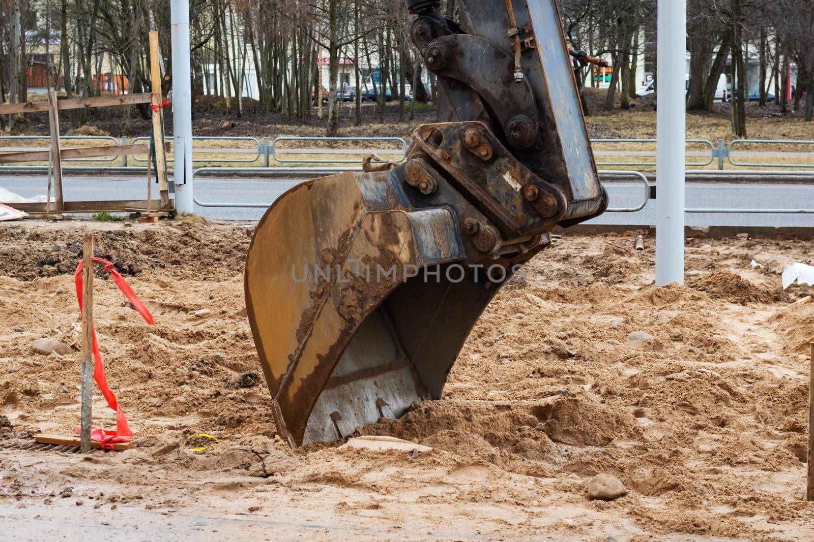 Excavator scoop close up on a construction site, copy space