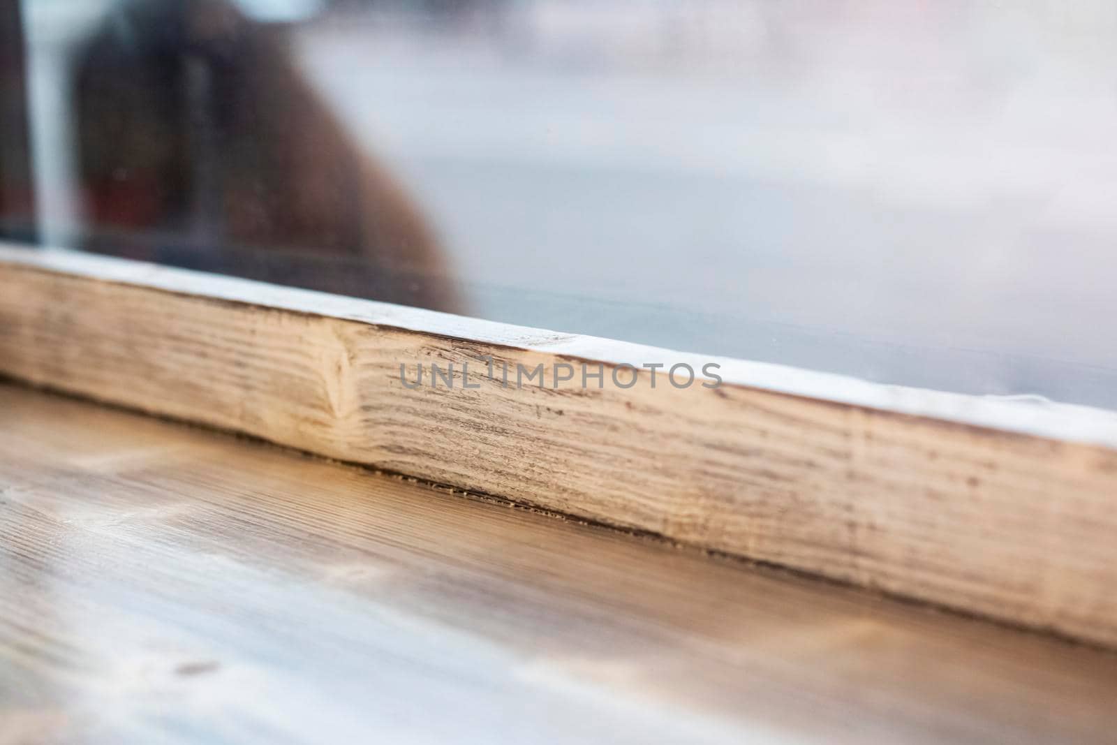 Wooden window sill and glass close up, background
