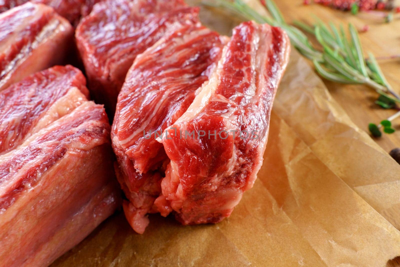Raw cowboy steak on wooden background, prime rib eye on bone. Close up