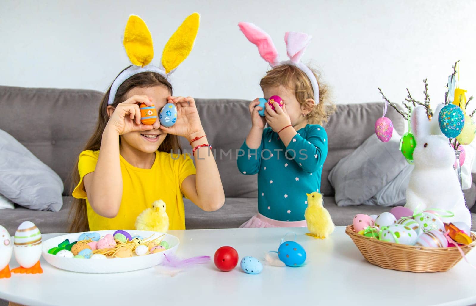 Happy Easter kids with eggs. Selective focus. by yanadjana