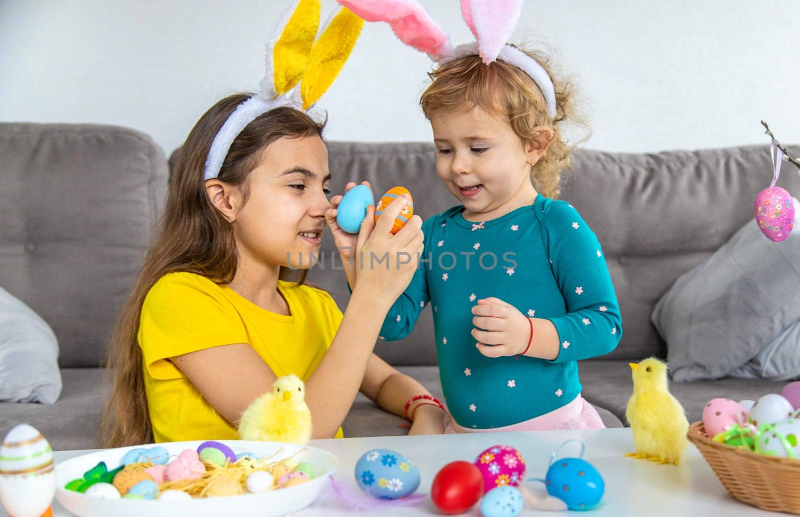 Happy Easter kids with eggs. Selective focus. by yanadjana