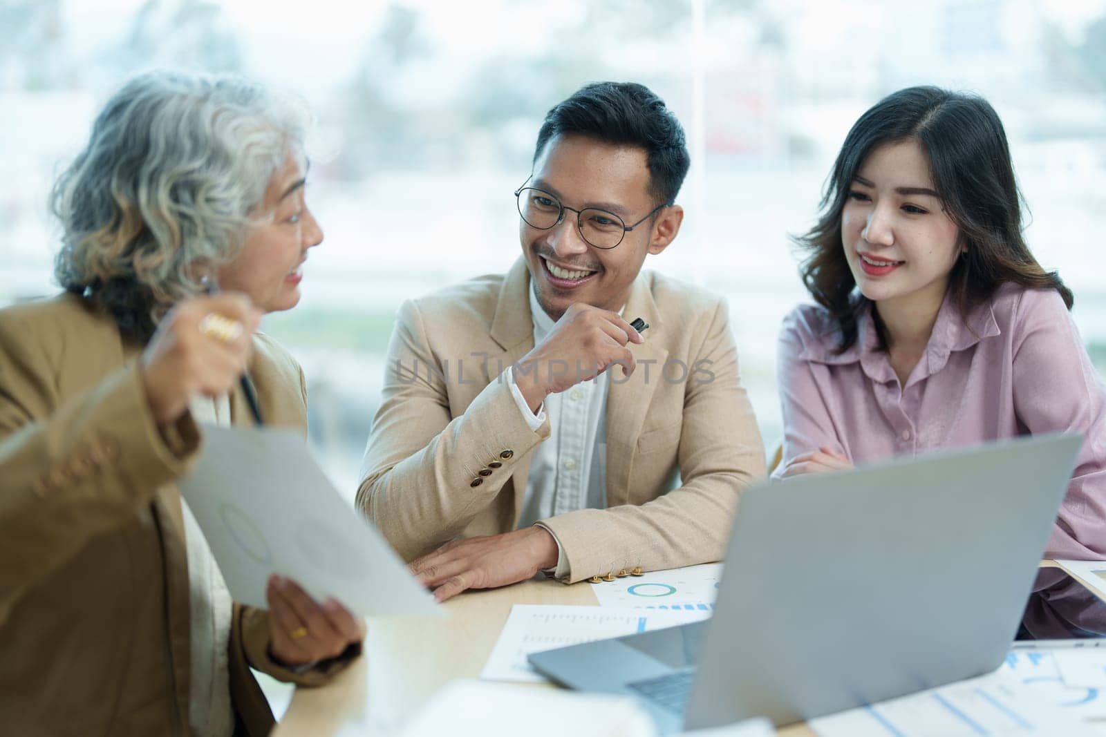 Asian entrepreneurs and business people meeting in a conference room in business planning, financial budget and investment risk assessment to analyze customer groups to increase company growth by Manastrong