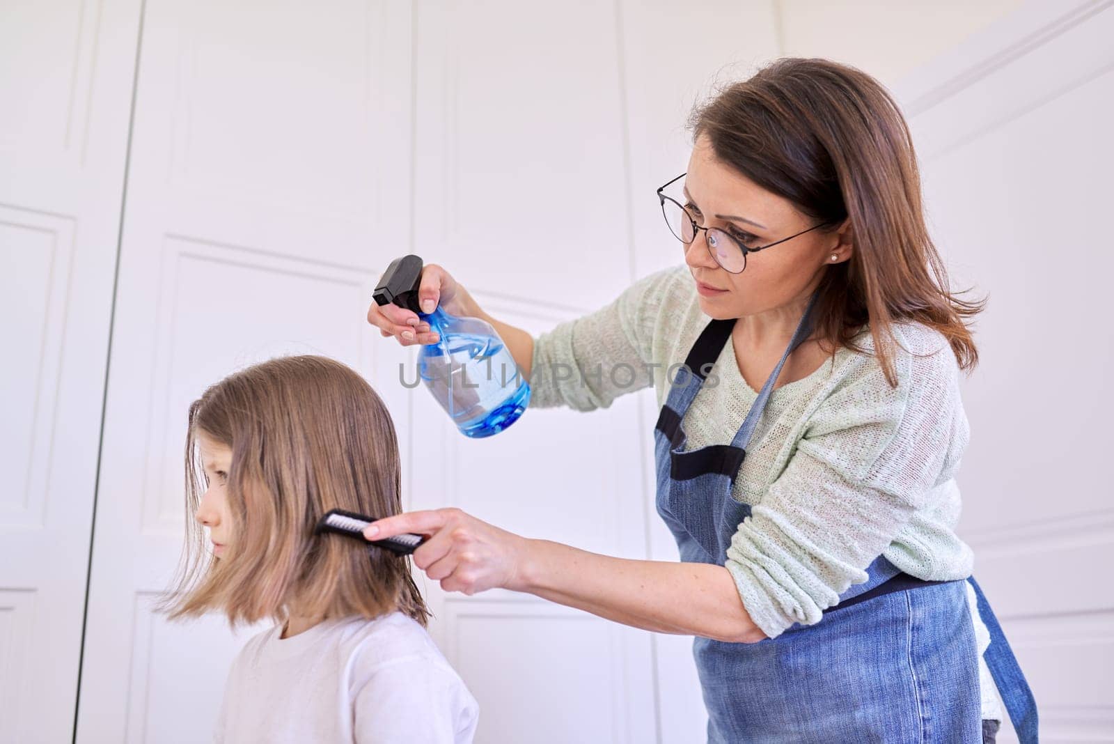 Mother cutting hair to daughter at home, children, hairstyles, hair, beauty by VH-studio