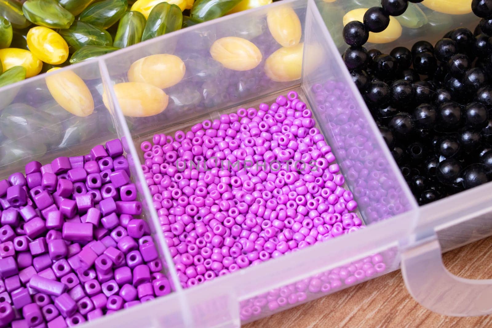 Colorful beads in containers close up, handicrafts, macrophoto