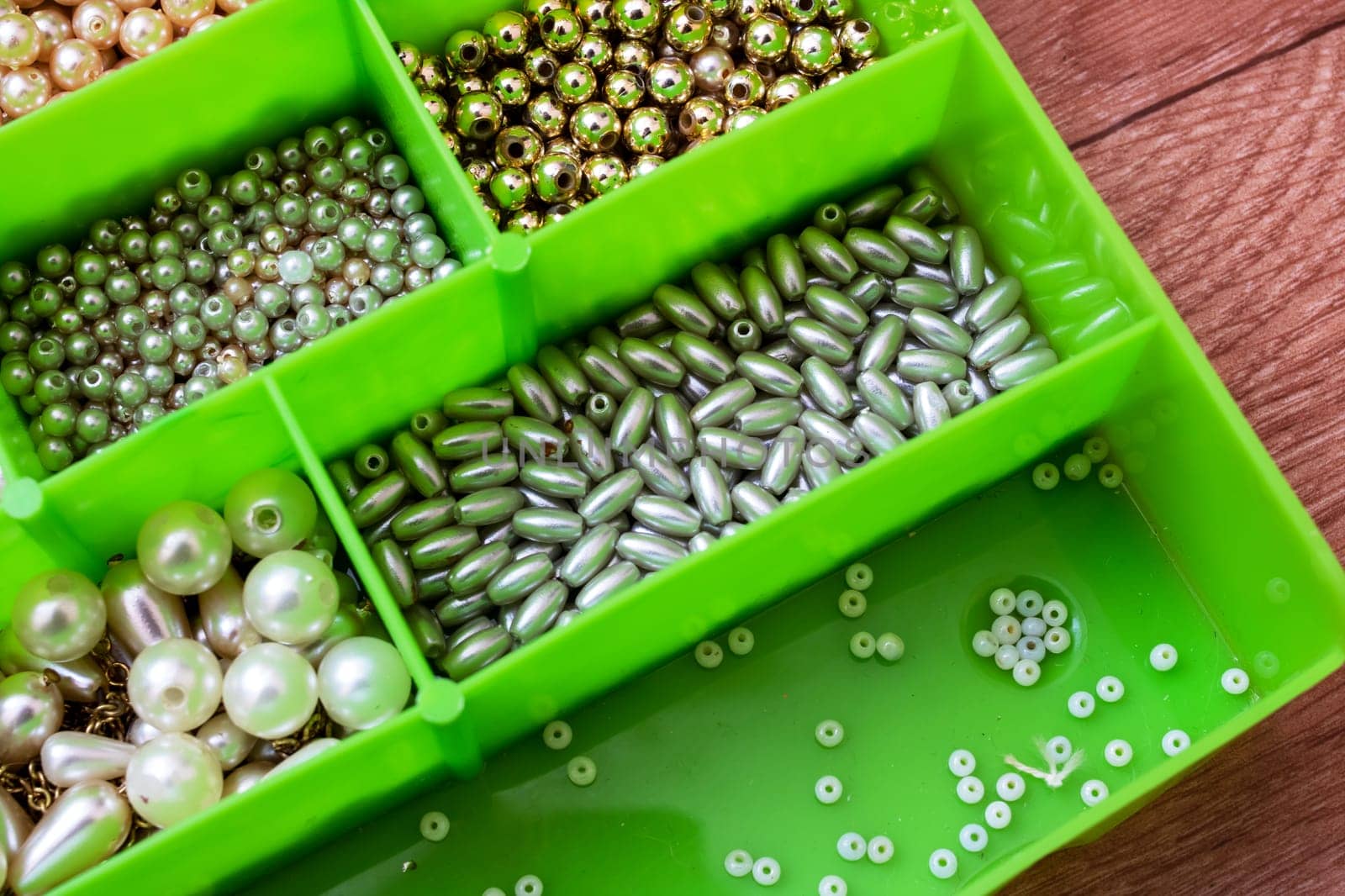 Colorful beads in containers close up, handicrafts, macrophoto