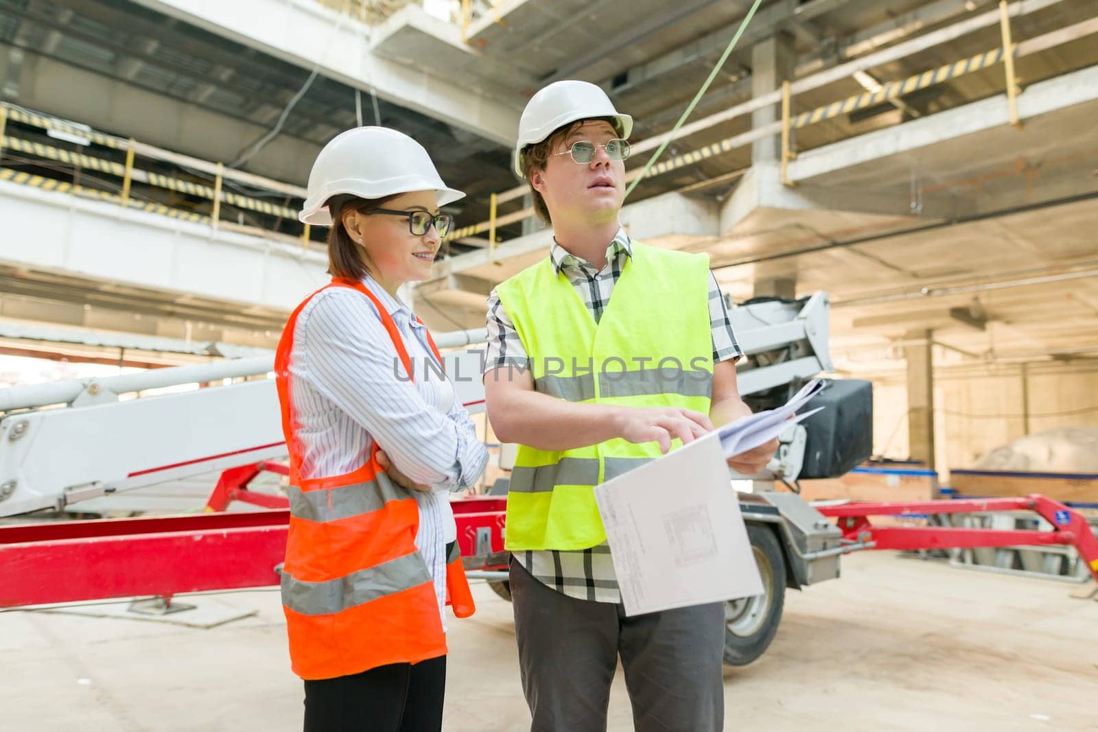Industrial portrait of male and female engineers in construction by VH-studio
