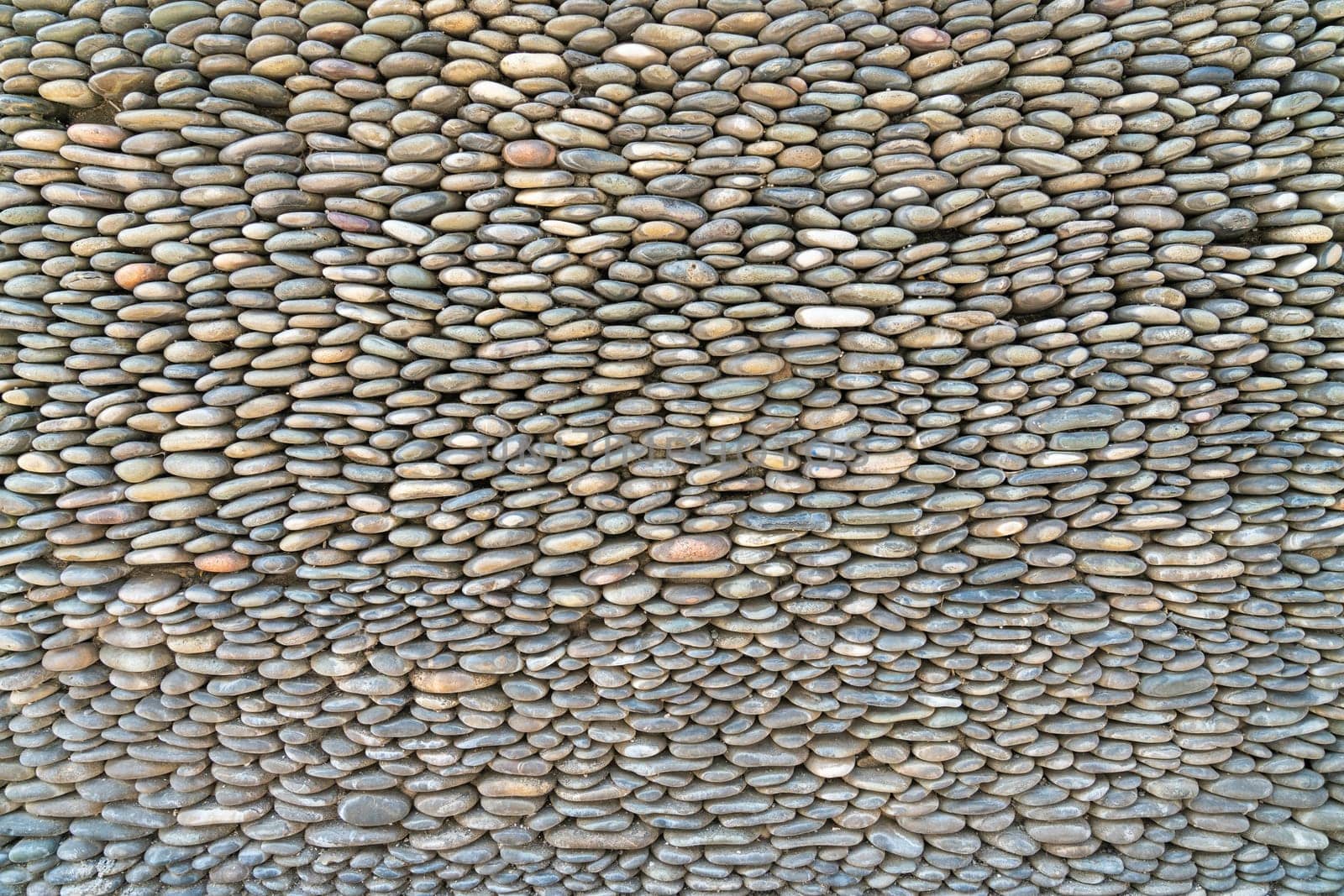 the texture of the pebbles in close-up as a background by roman112007