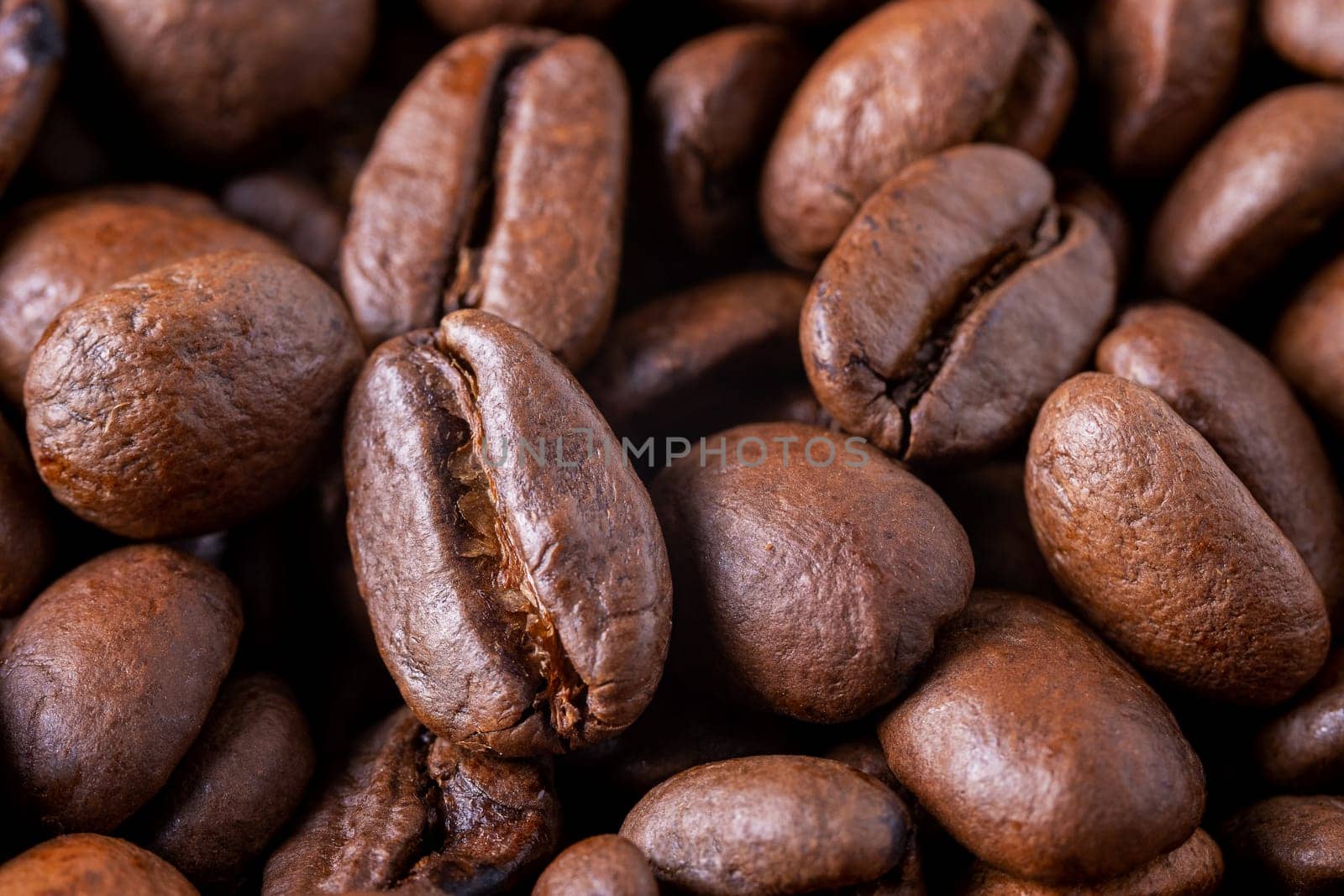 Close-up of roasted coffee beans as background. Selective focus.