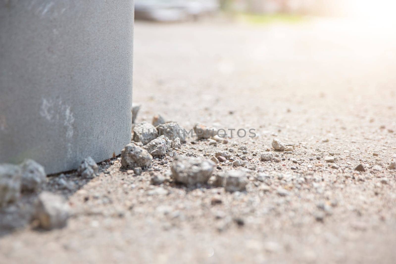 The emergency state of the building, the foundation of the old building is crumbling, pieces of old crumbling concrete lie on the asphalt, violations in the construction of buildings