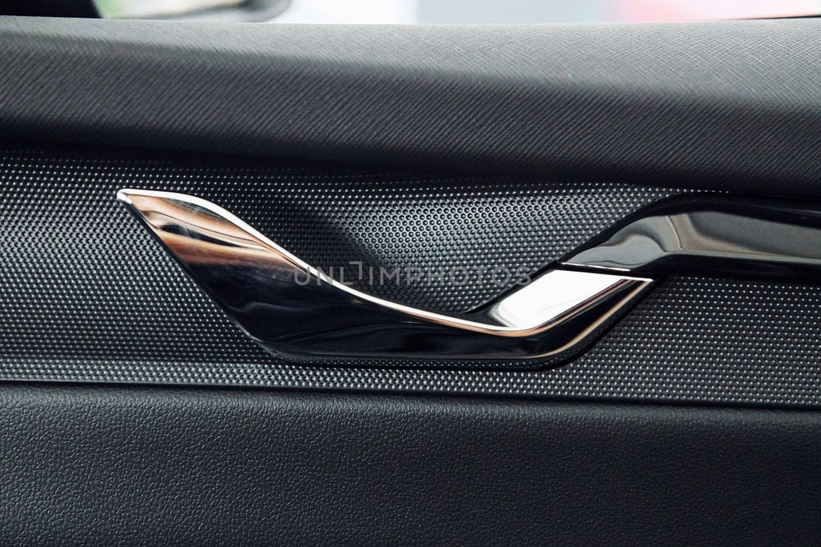 Car's window. Close up focused view of brand new modern black automobile.