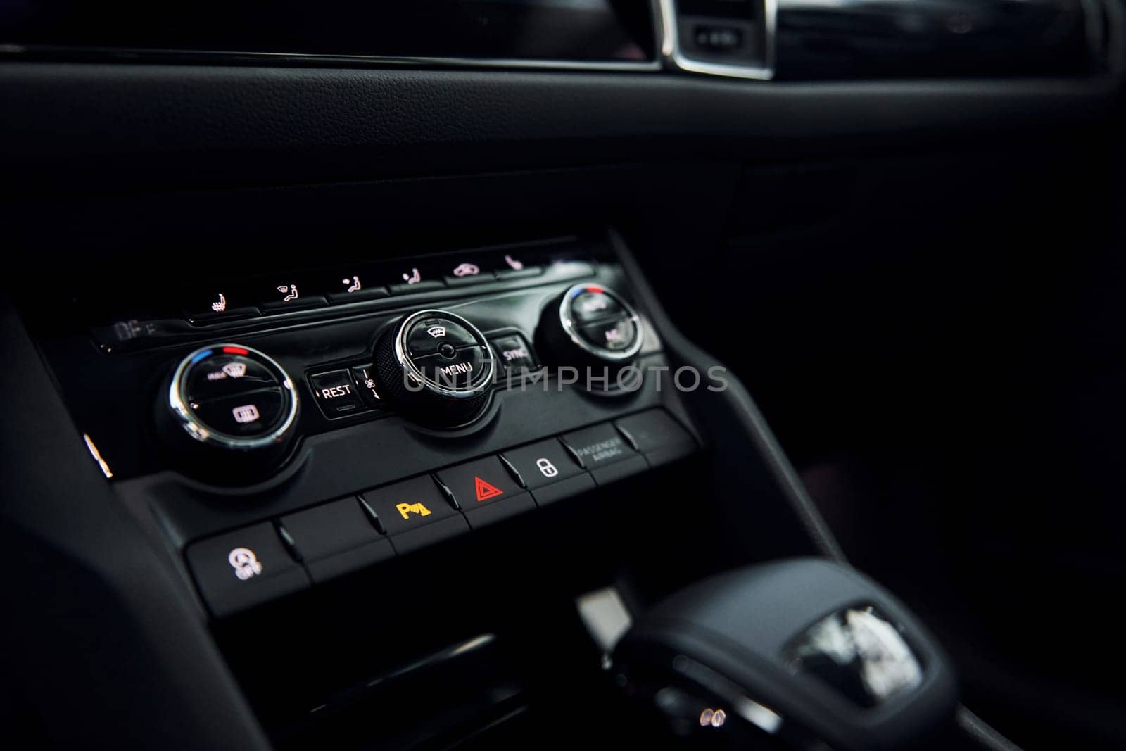 Knobs and buttons. Close up focused view of brand new modern black automobile.