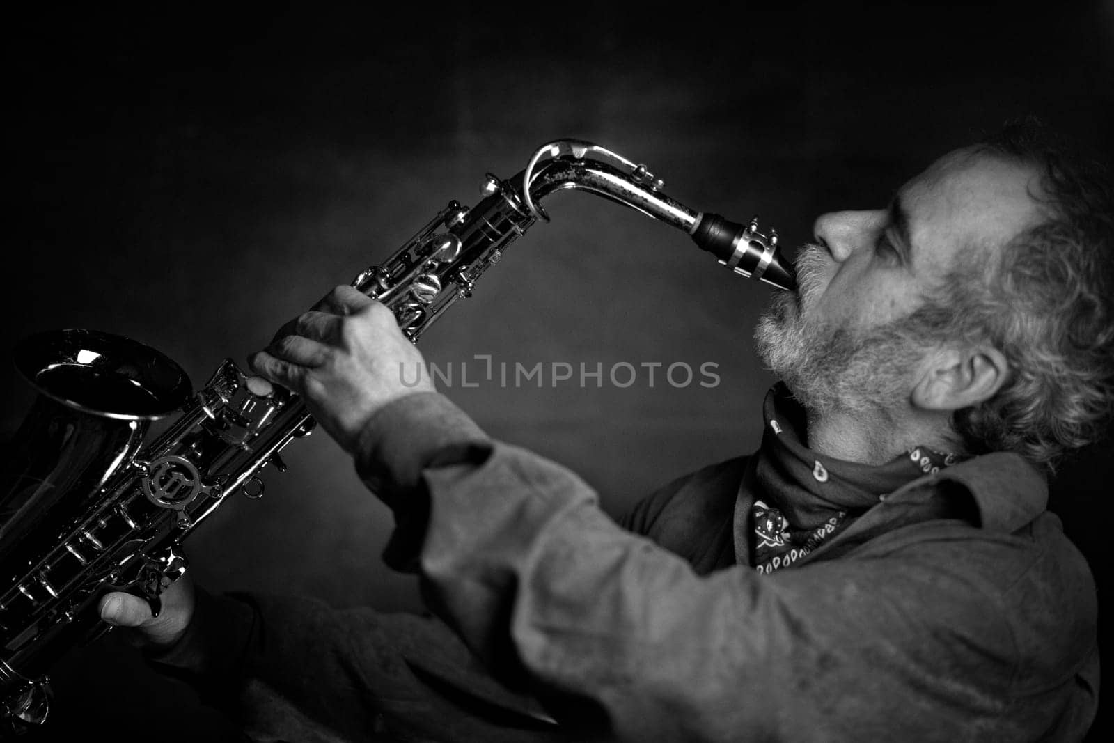 Saxophone player Saxophonist playing jazz music instrument Jazz musician playing sax alto, Profile shot of a musician playing a saxophone isolated on black background, High quality photo