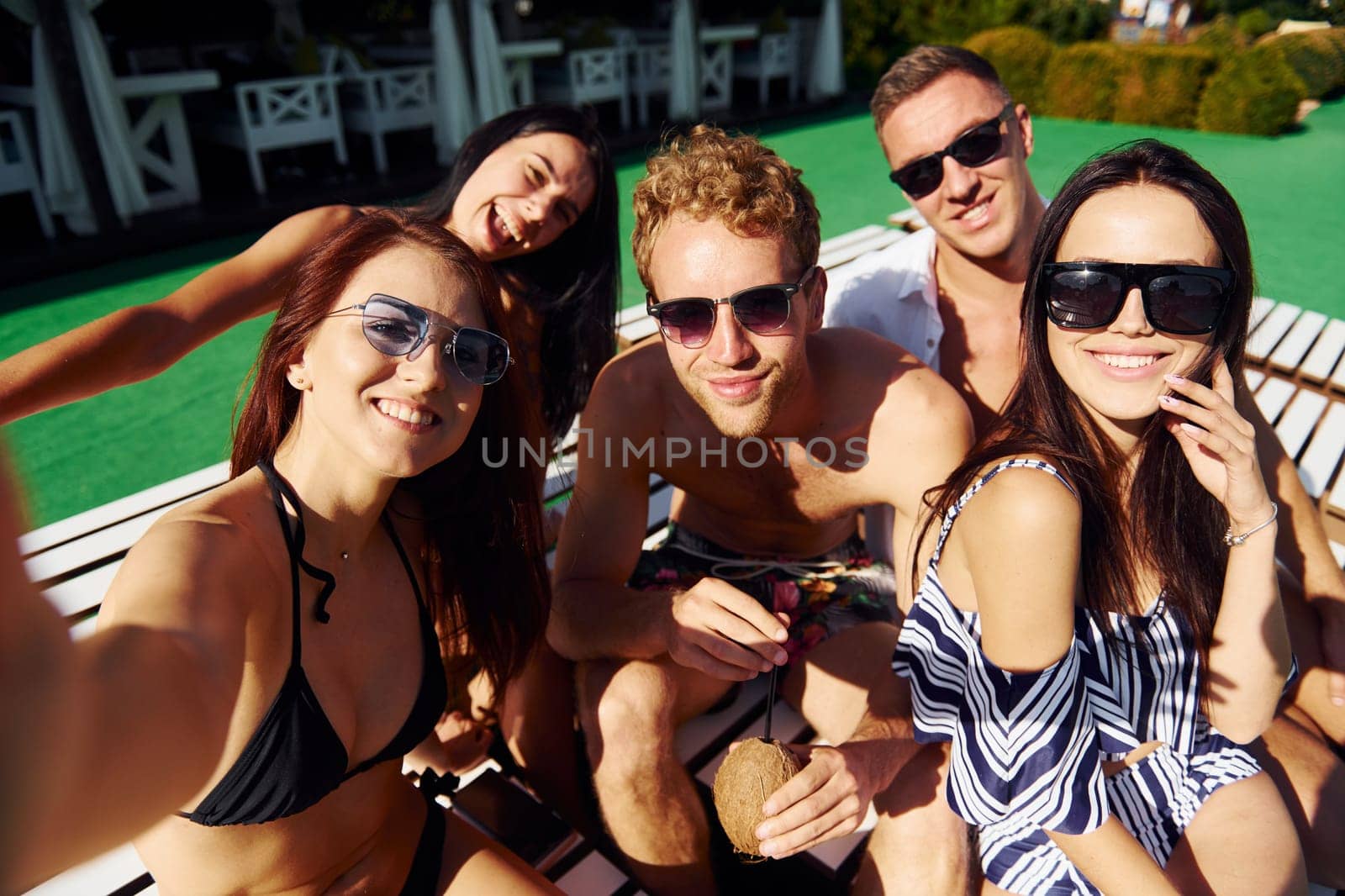 Group of young happy people have fun at backyard at daytime.