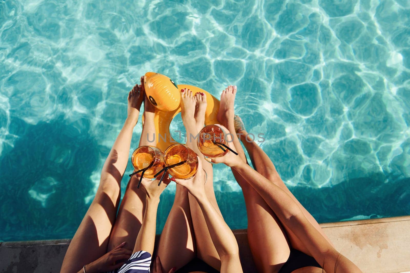 Top view of group of young happy people that have fun in swimming pool at daytime by Standret