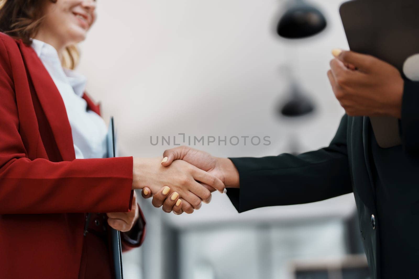 Multi ethnic business Financial shaking hands, Successful businessmen handshaking after good deal. Business Finishing up meeting contract concept by Manastrong