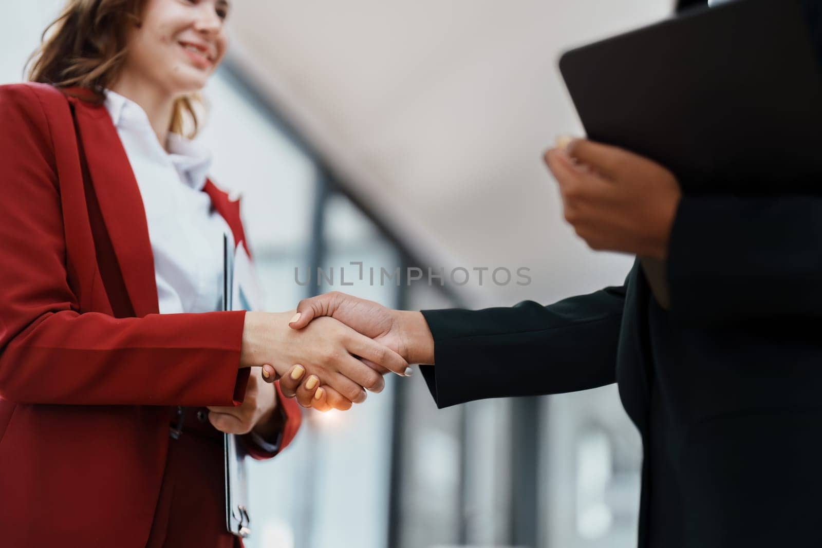 Multi ethnic business Financial shaking hands, Successful businessmen handshaking after good deal. Business Finishing up meeting contract concept by Manastrong