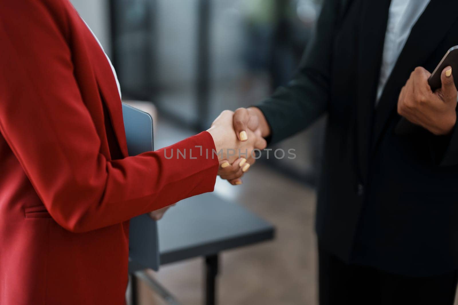 Multi ethnic business Financial shaking hands, Successful businessmen handshaking after good deal. Business Finishing up meeting contract concept by Manastrong