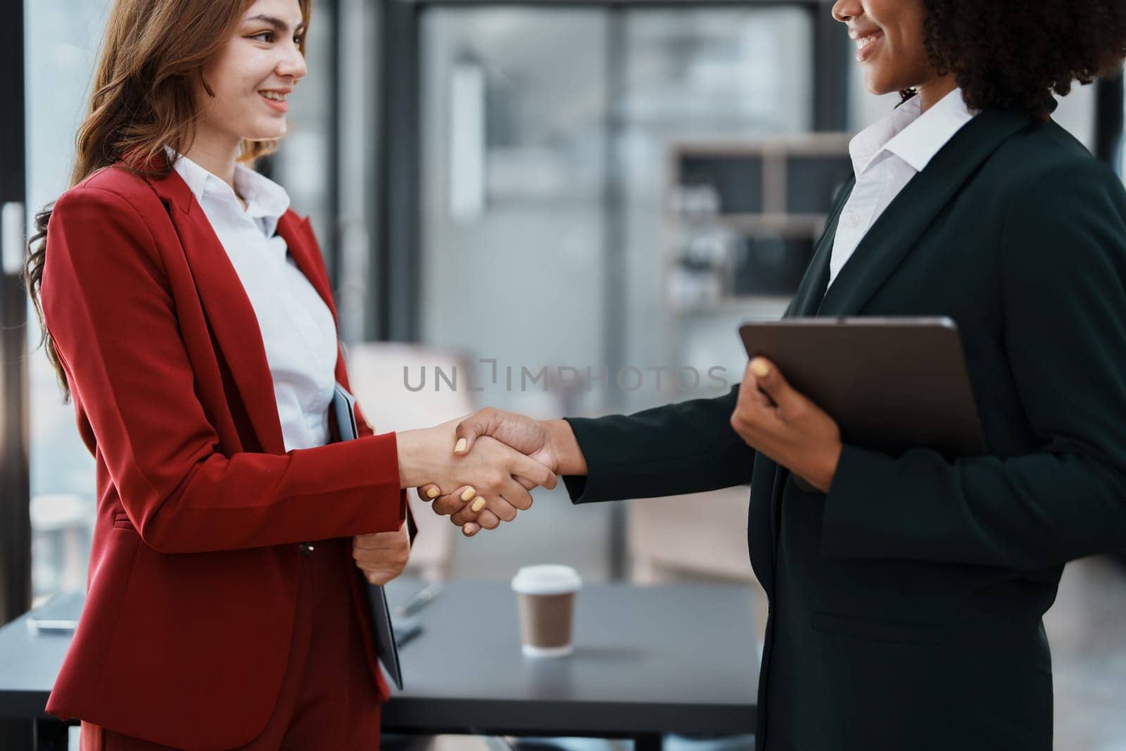 Multi ethnic business Financial shaking hands, Successful businessmen handshaking after good deal. Business Finishing up meeting contract concept by Manastrong