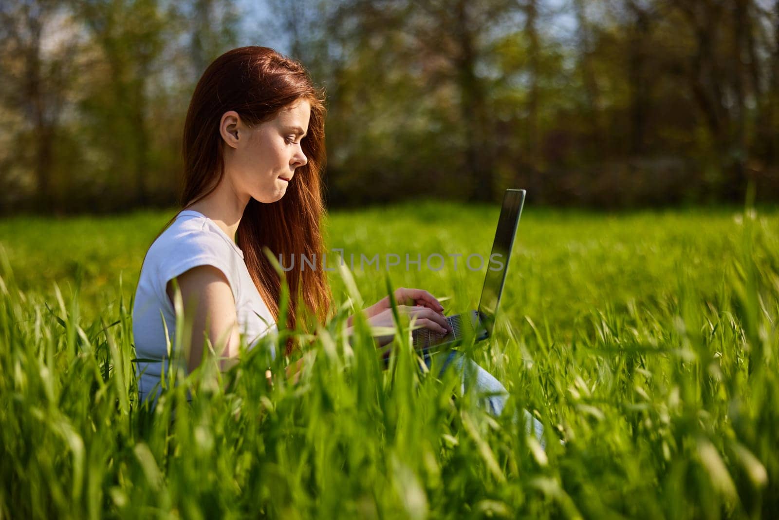 woman with laptop outdoors by Vichizh