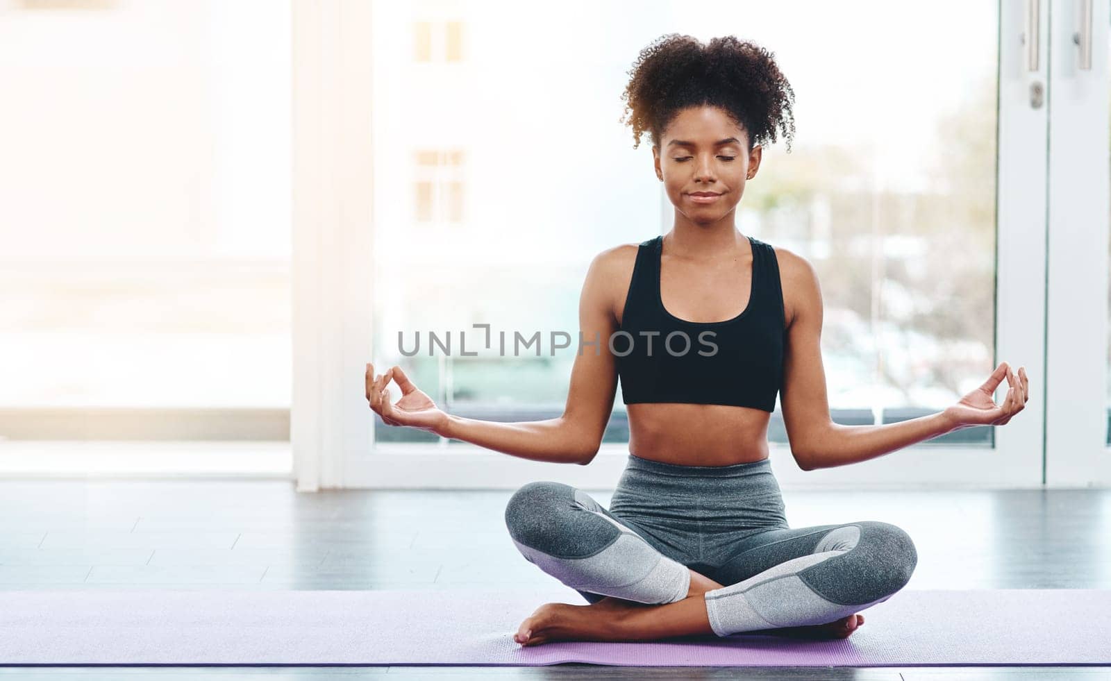 Try yoga after a hard day. a beautiful young woman practising yoga in a studio. by YuriArcurs