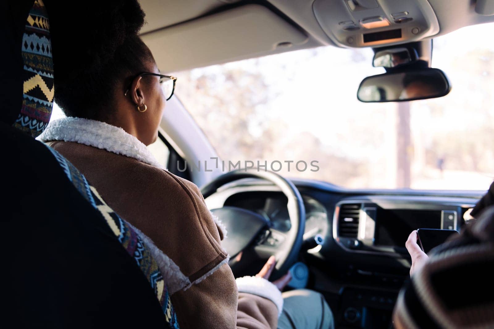 rear view of a young woman driving her camper van by raulmelldo