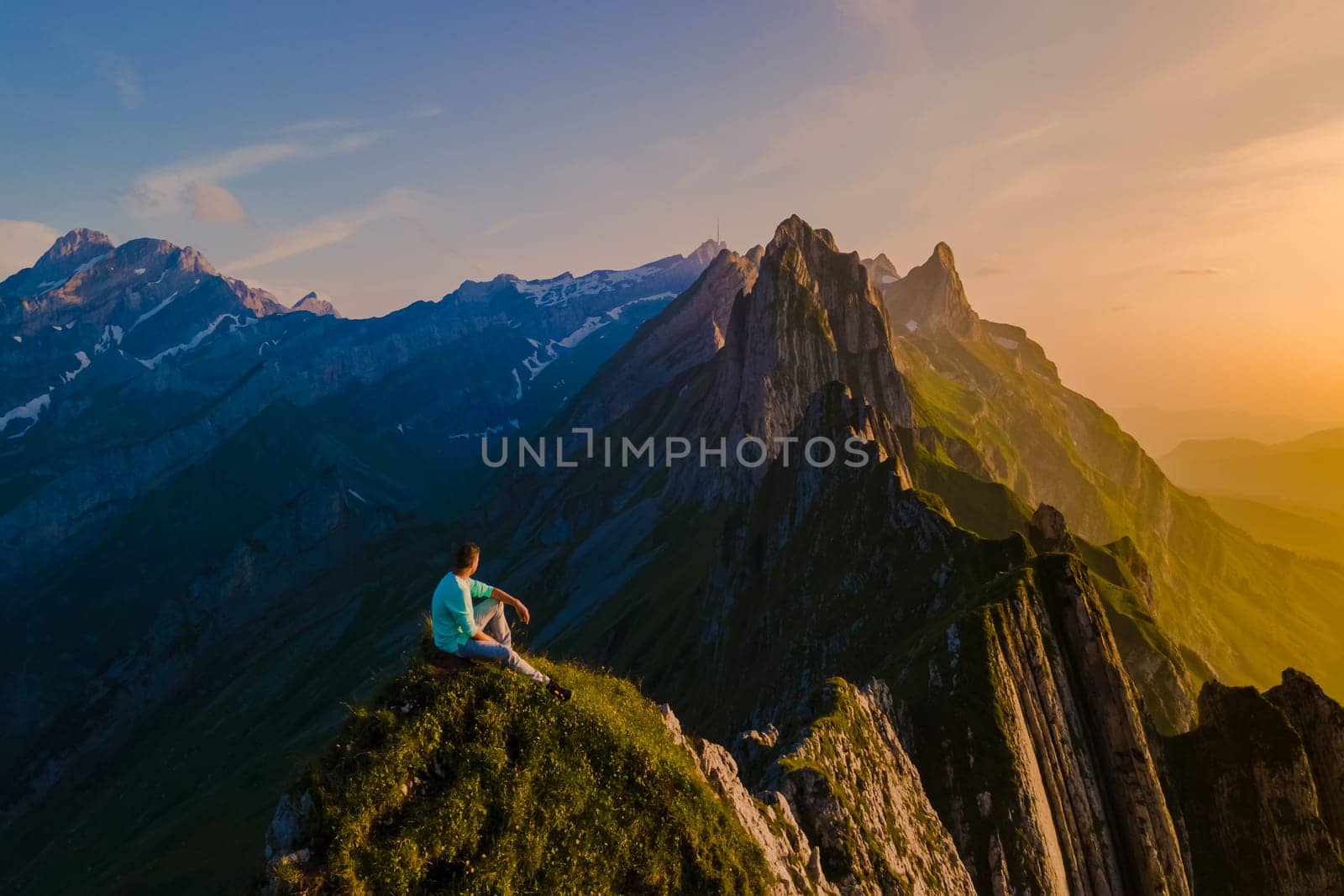 Schaeffler mountain ridge swiss Alpstein, Appenzell Switzerland, a ridge of the majestic Schaeffler peak by Berggasthaus Schafler, Switzerland. man in the mountains during sunset