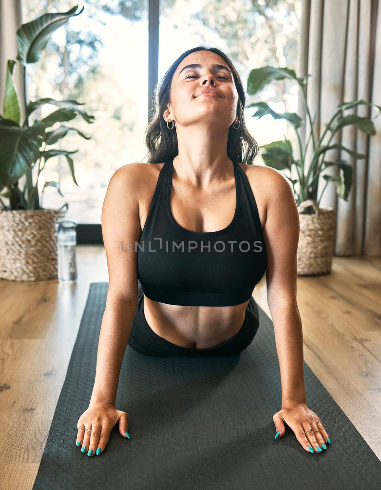 Yoga meditation, cobra stretch and woman in home for health, wellness and flexibility exercise. Pilates, workout and female yogi stretching, holistic training and exercising in house for fitness. by YuriArcurs