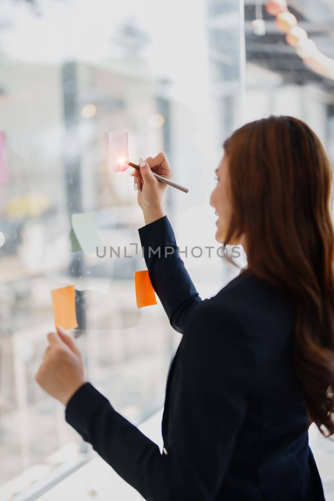 Beautiful young teen asian businesswoman using note pad thinking with planning working on financial document, tax, exchange, accounting and Financial advisor by Manastrong