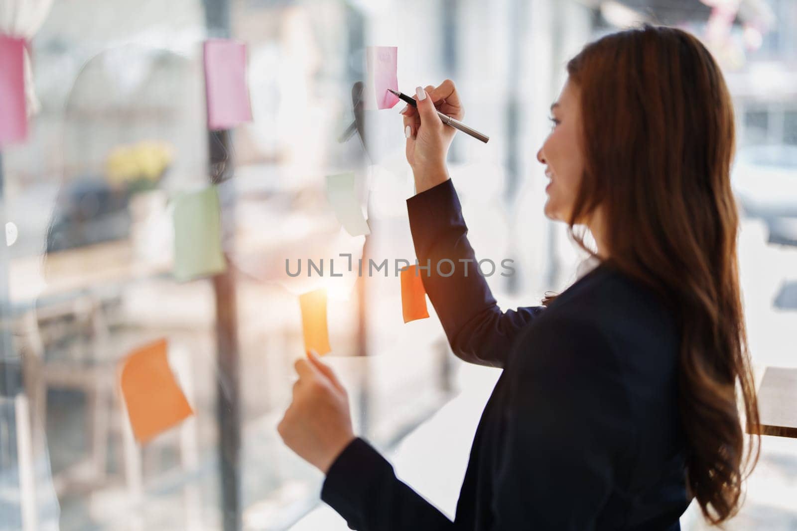 Beautiful young teen asian businesswoman using note pad thinking with planning working on financial document, tax, exchange, accounting and Financial advisor.