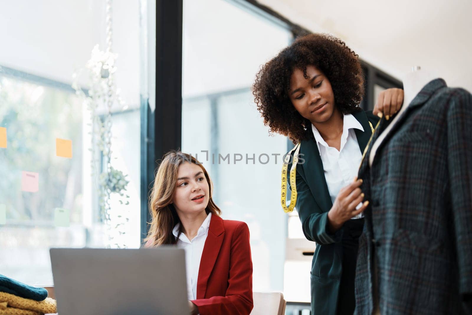 Multi ethnic young teen african american and asian woman fashion designer stylish and friend working at fashion Business studio by Manastrong