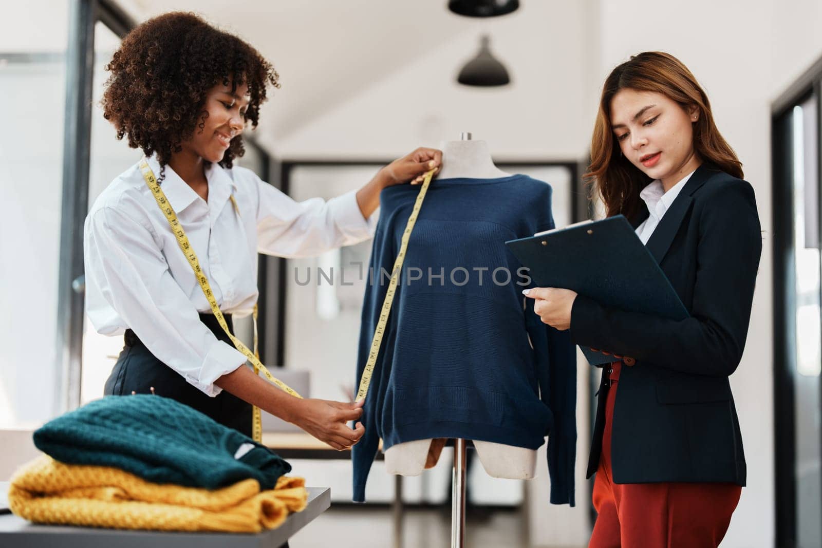 Multi ethnic young teen african american and asian woman fashion designer stylish and friend working at fashion Business studio by Manastrong