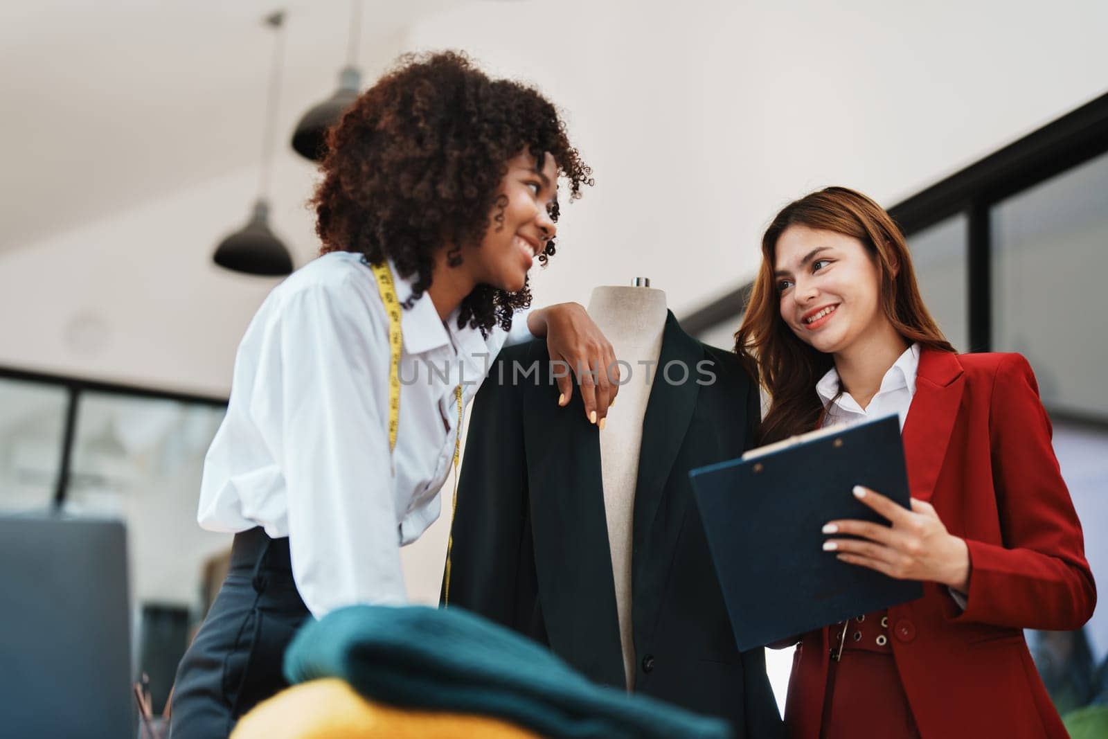 Multi ethnic young teen african american and asian woman fashion designer stylish and friend working at fashion Business studio.