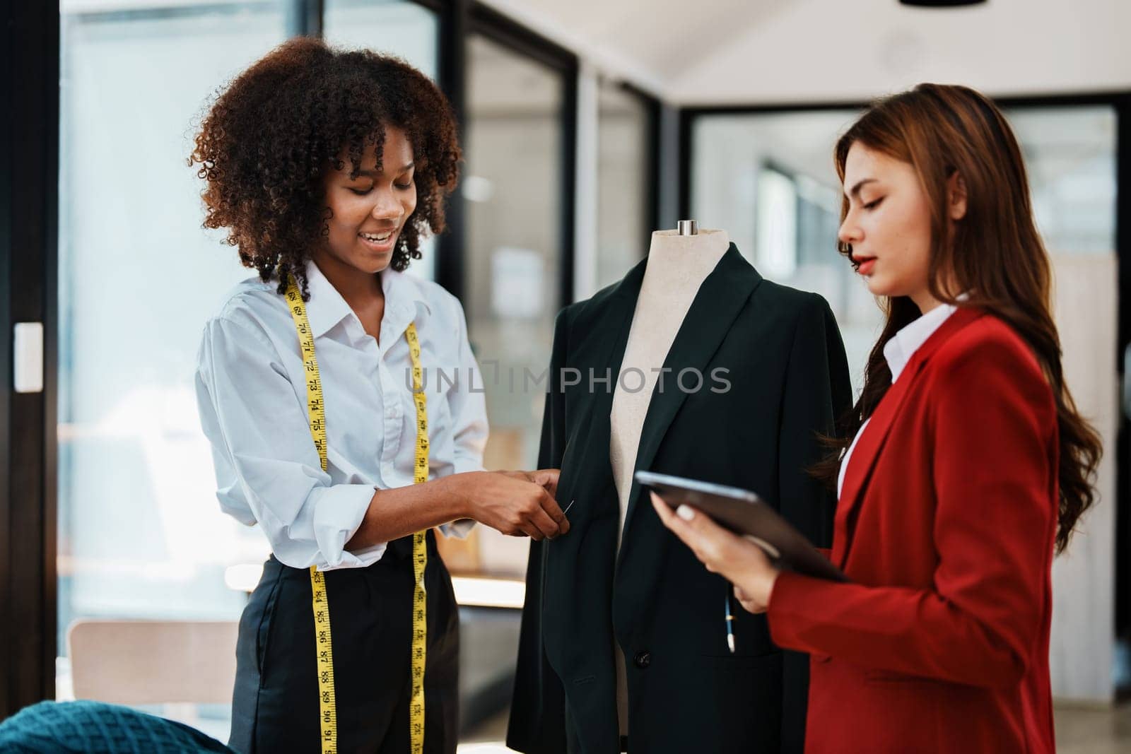 Multi ethnic young teen african american and asian woman fashion designer stylish and friend working at fashion Business studio by Manastrong