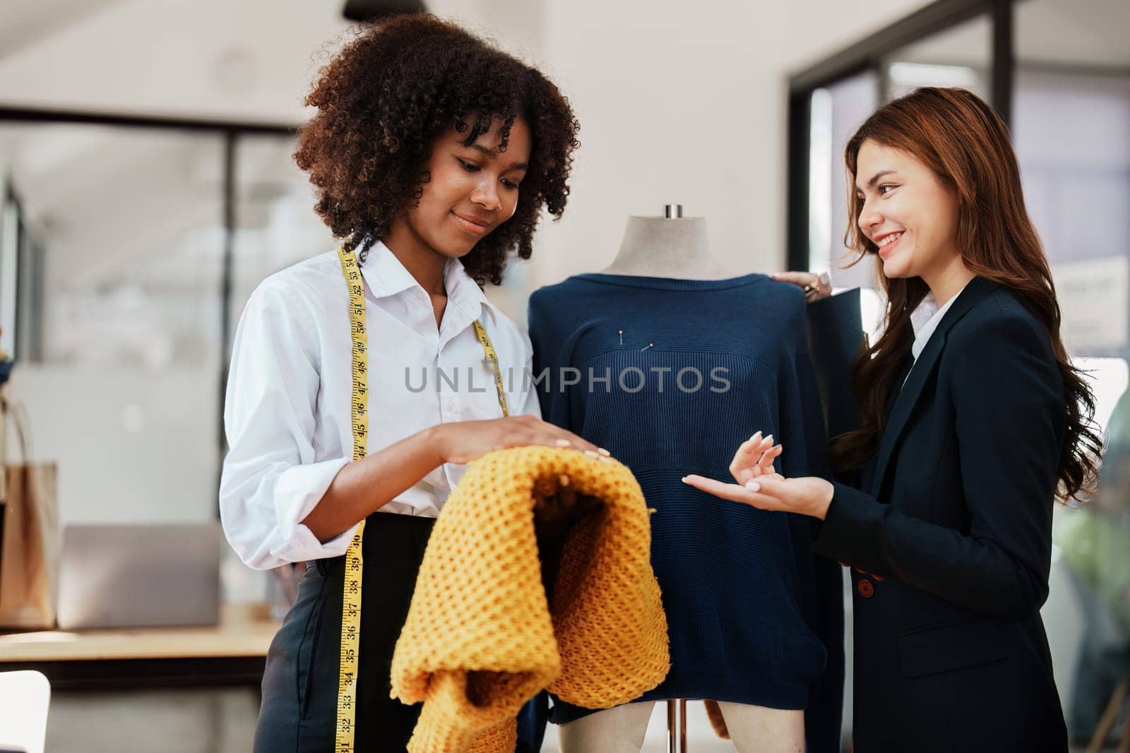 Multi ethnic young teen african american and asian woman fashion designer stylish and friend working at fashion Business studio by Manastrong