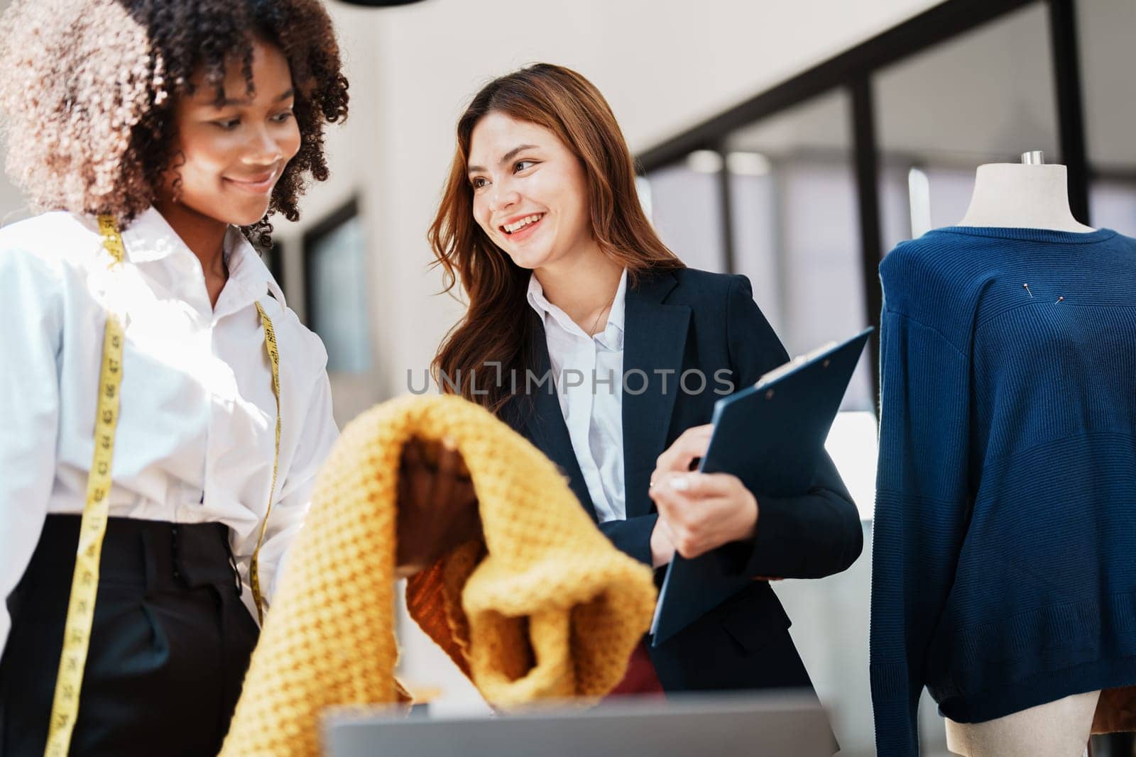 Multi ethnic young teen african american and asian woman fashion designer stylish and friend working at fashion Business studio by Manastrong