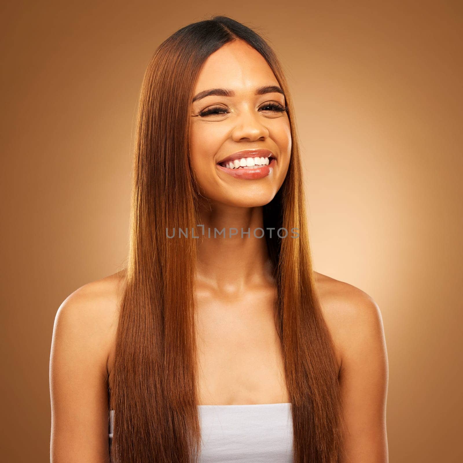 Hair, beauty and smile portrait of woman in studio for growth and color shine or healthy texture. Aesthetic female happy for haircare, natural makeup and hairdresser or salon on a brown background by YuriArcurs