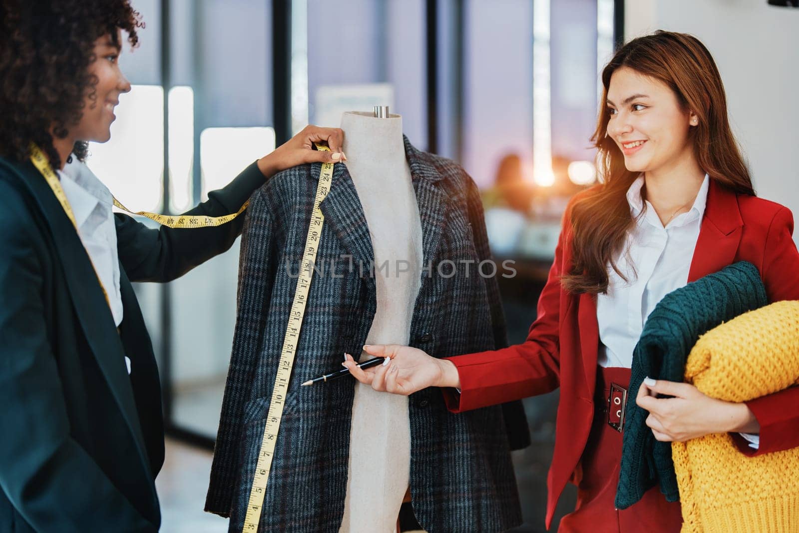 Multi ethnic young teen african american and asian woman fashion designer stylish and friend working at fashion Business studio.