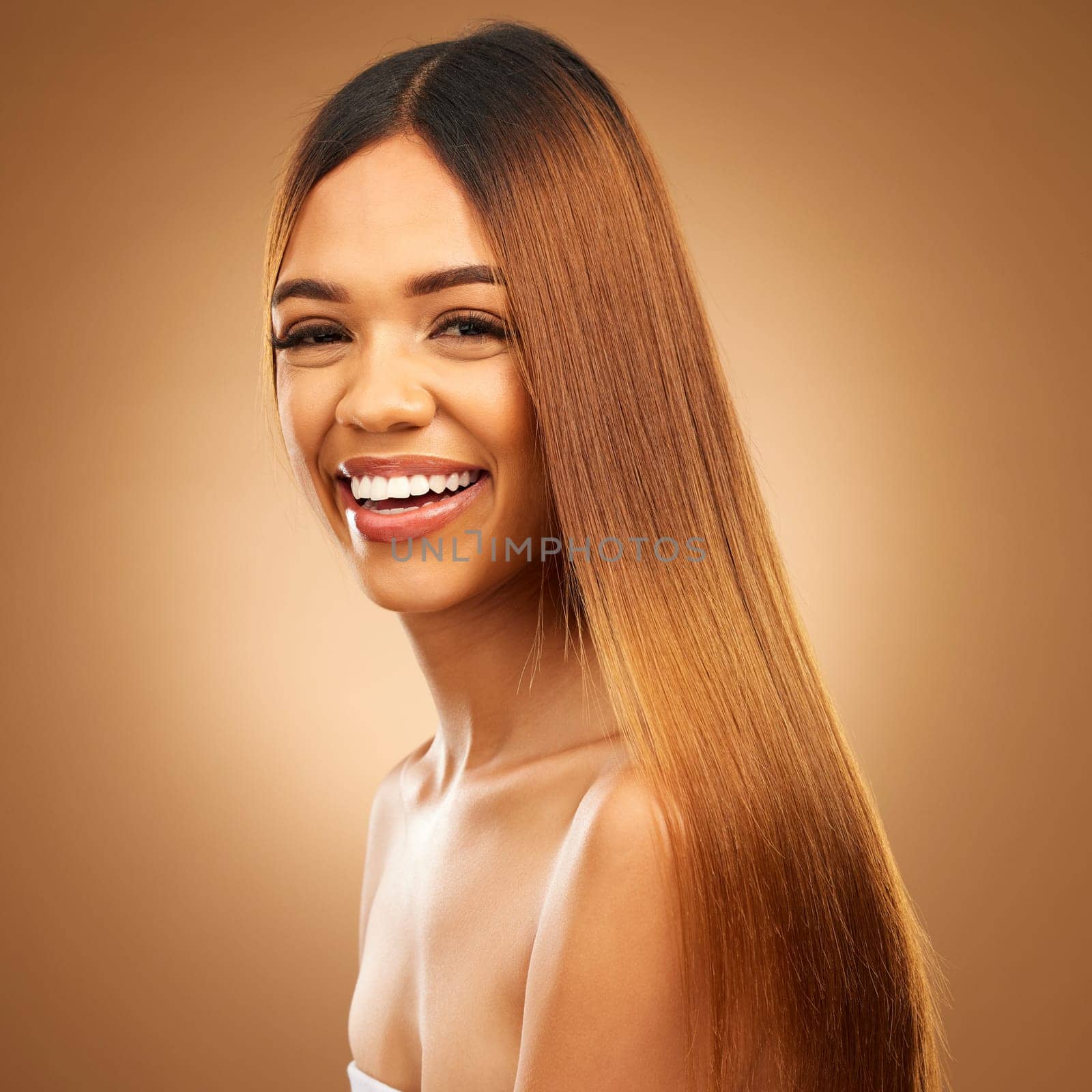 Portrait, beauty and hair care of woman in studio for growth and color shine or healthy texture. Aesthetic female happy face for haircare, natural makeup and hairdresser or salon on brown background by YuriArcurs