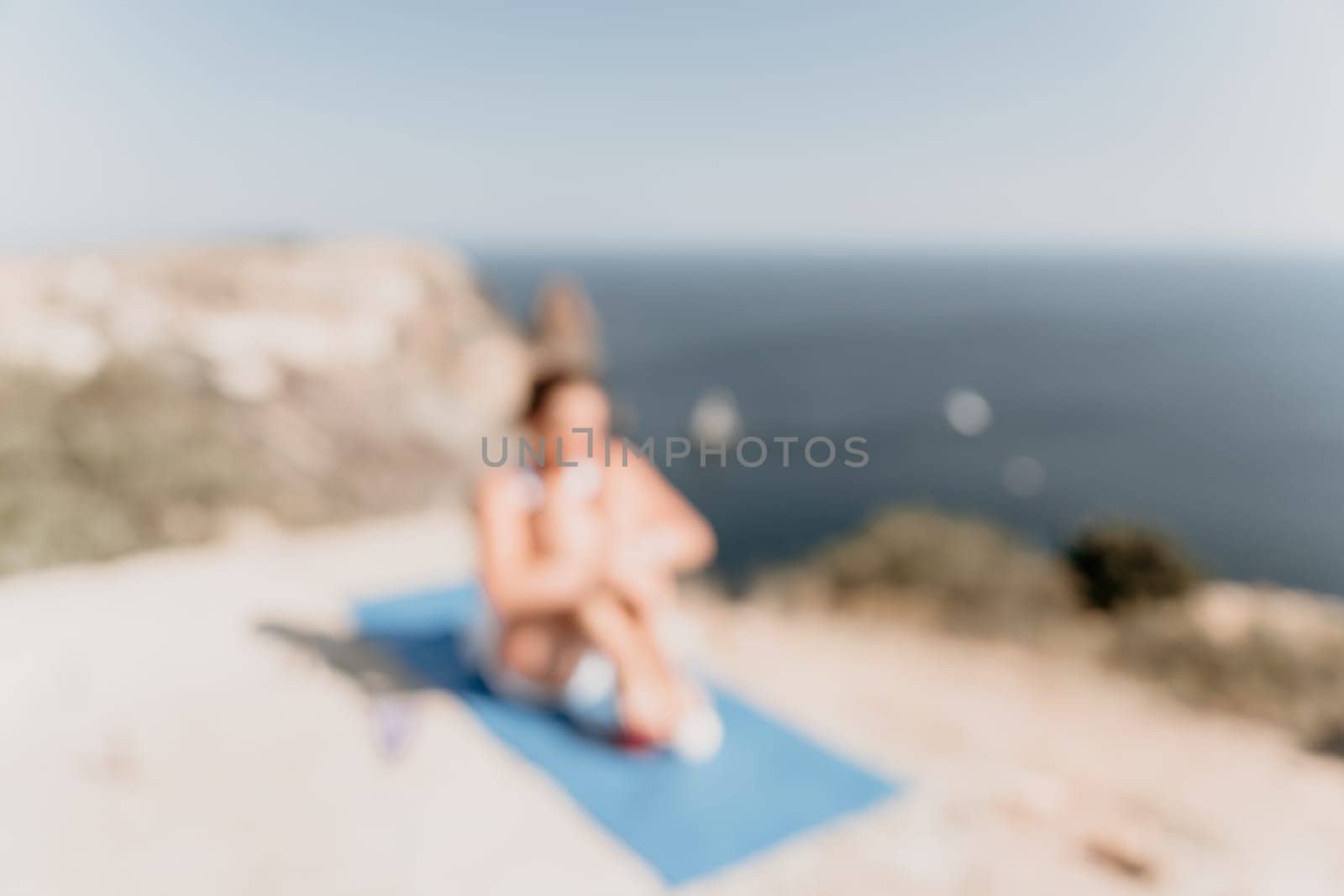 Fitness woman sea. Outdoor workout on yoga mat in park near to ocean beach. Female fitness pilates yoga routine concept. Healthy lifestyle. Happy fit woman exercising with rubber band in park.