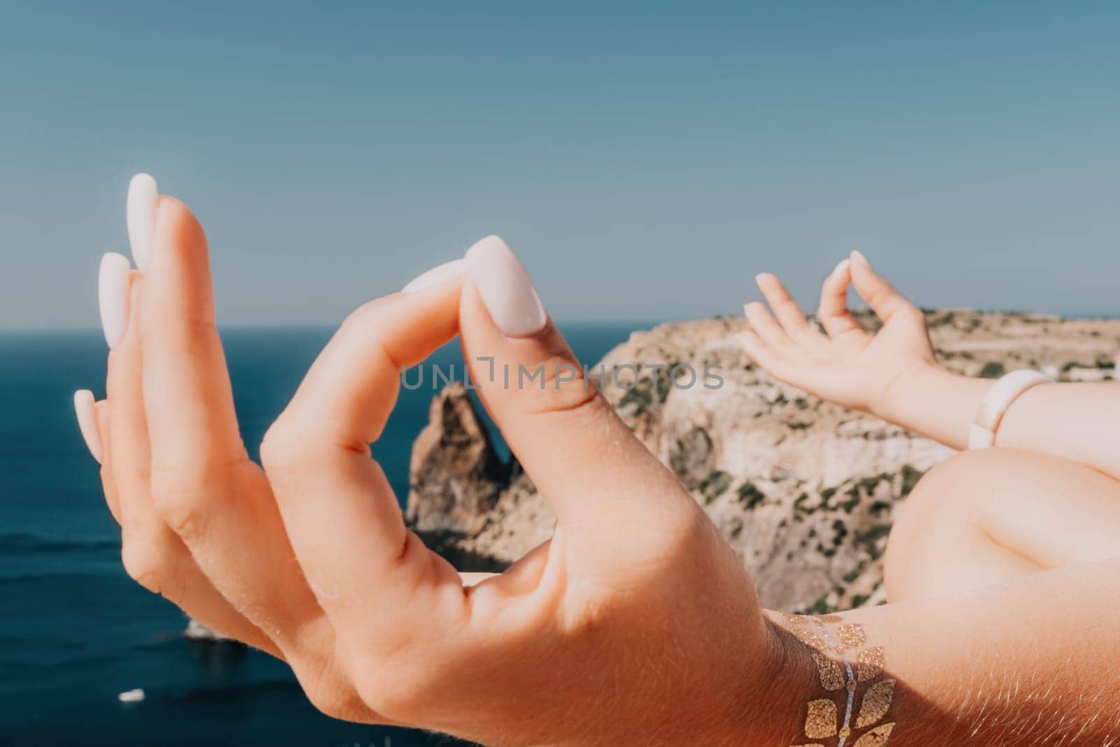 Woman meditating in yoga pose silhouette at the ocean, beach and rock mountains. Motivation and inspirational fit and exercising. Healthy lifestyle outdoors in nature, fitness concept.