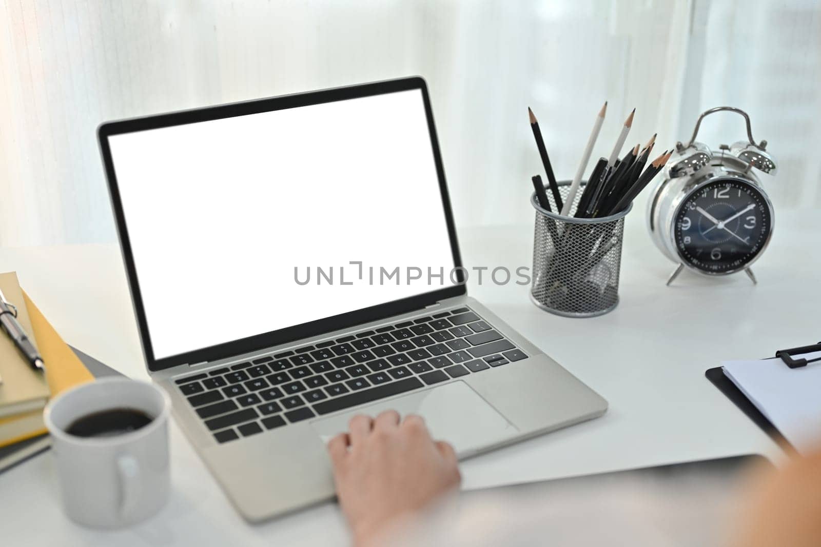 Close up view of female worker hand typing on keyboard of laptop, white empty screen for your advertising text message.
