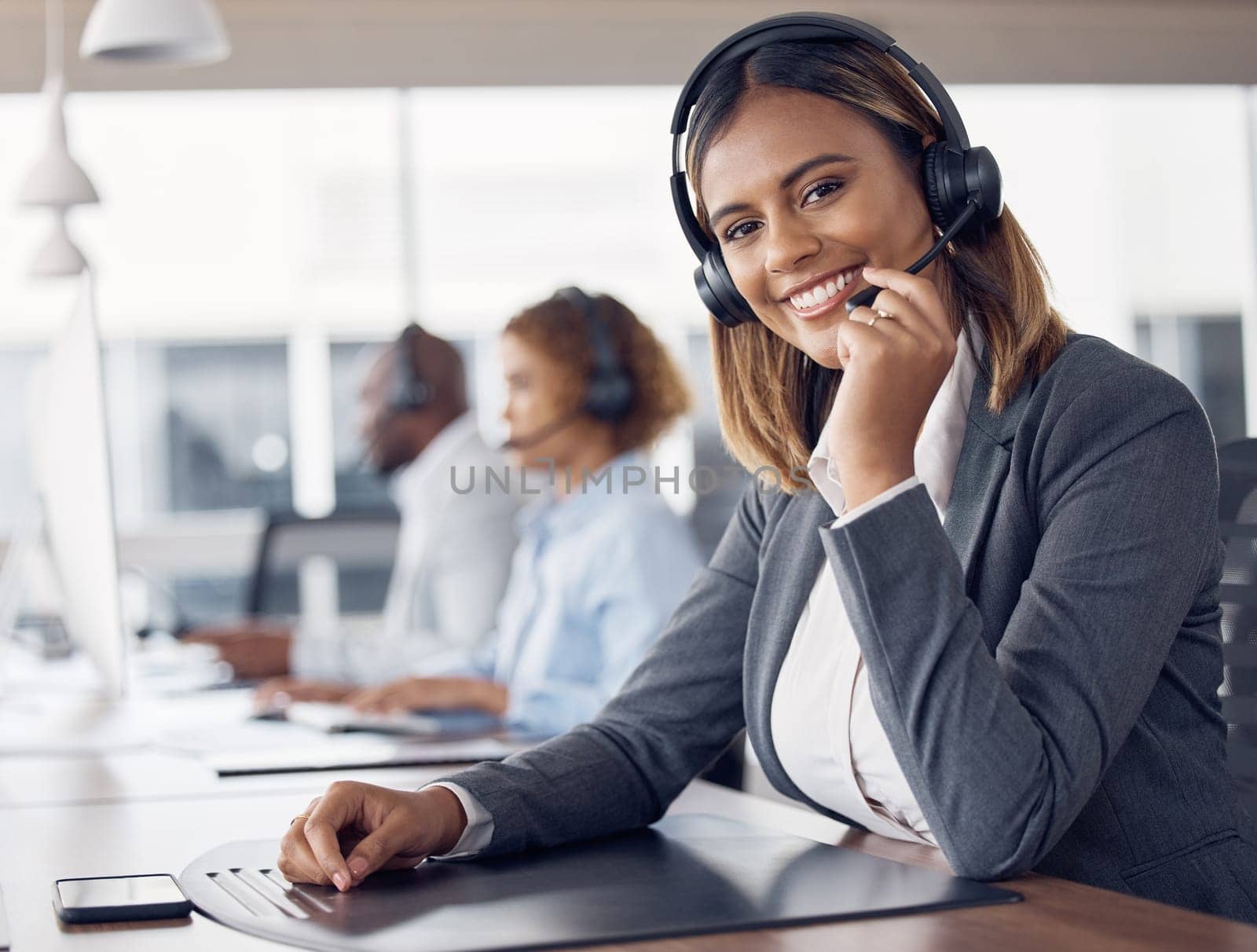 Call center woman, portrait and smile in office for customer support job, happiness or microphone at desk. Indian telemarketing consultant, desktop pc or happy crm with communication in workplace.