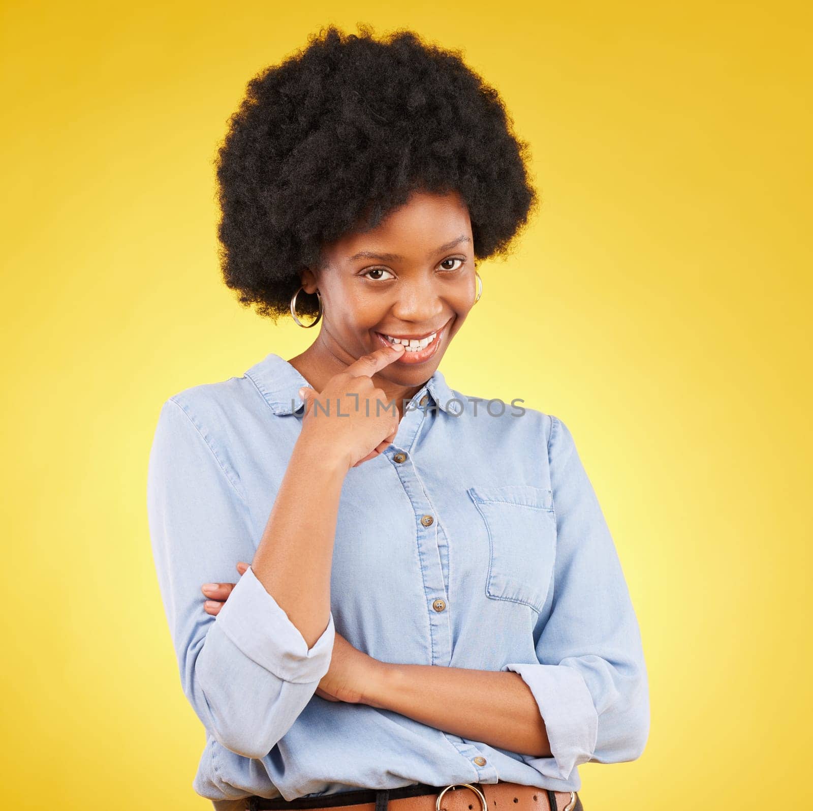 Happy, flirting and portrait of a black woman in a studio with confidence, love and romance face. Happiness, smirk and African female model biting her finger for a sexy gesture by a yellow background by YuriArcurs