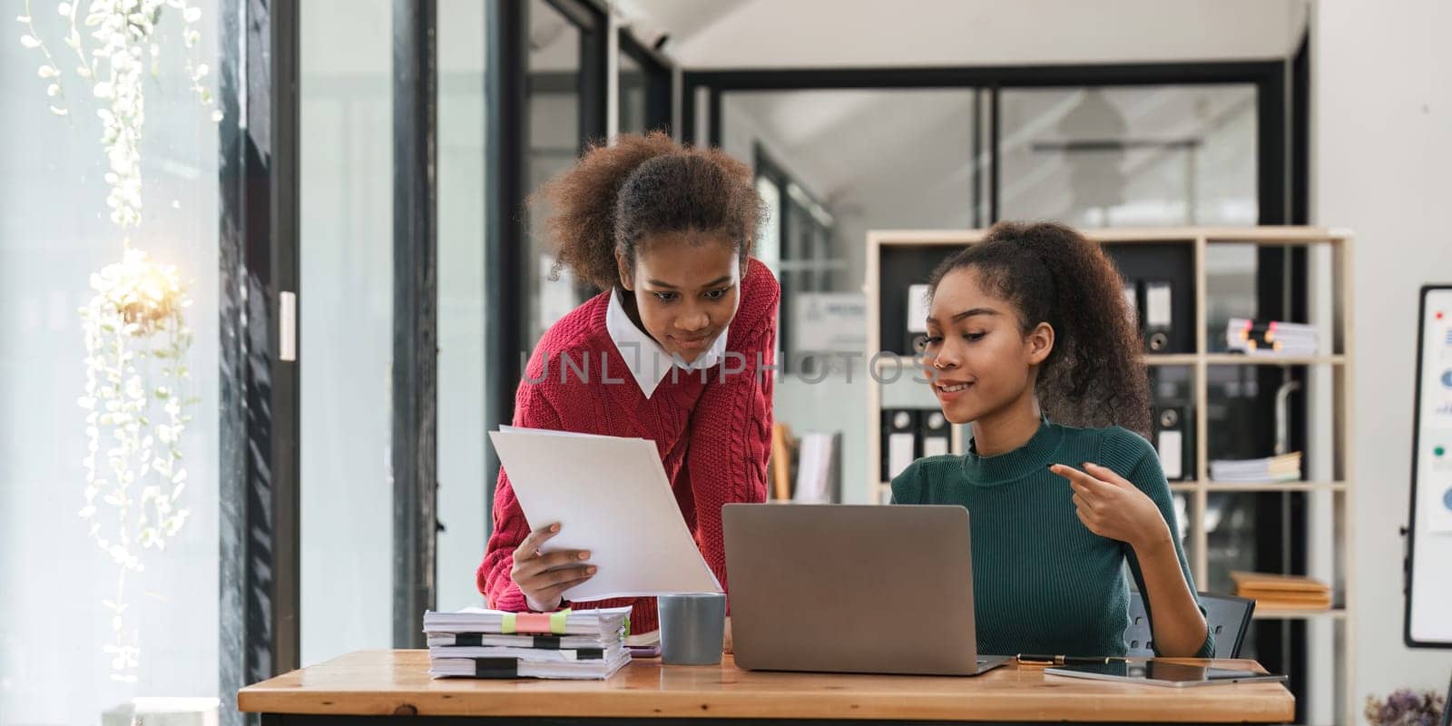 Young group of diverse students studying together using laptop at home. College multiracial people working on university group assignment homework project in modern apartment by nateemee