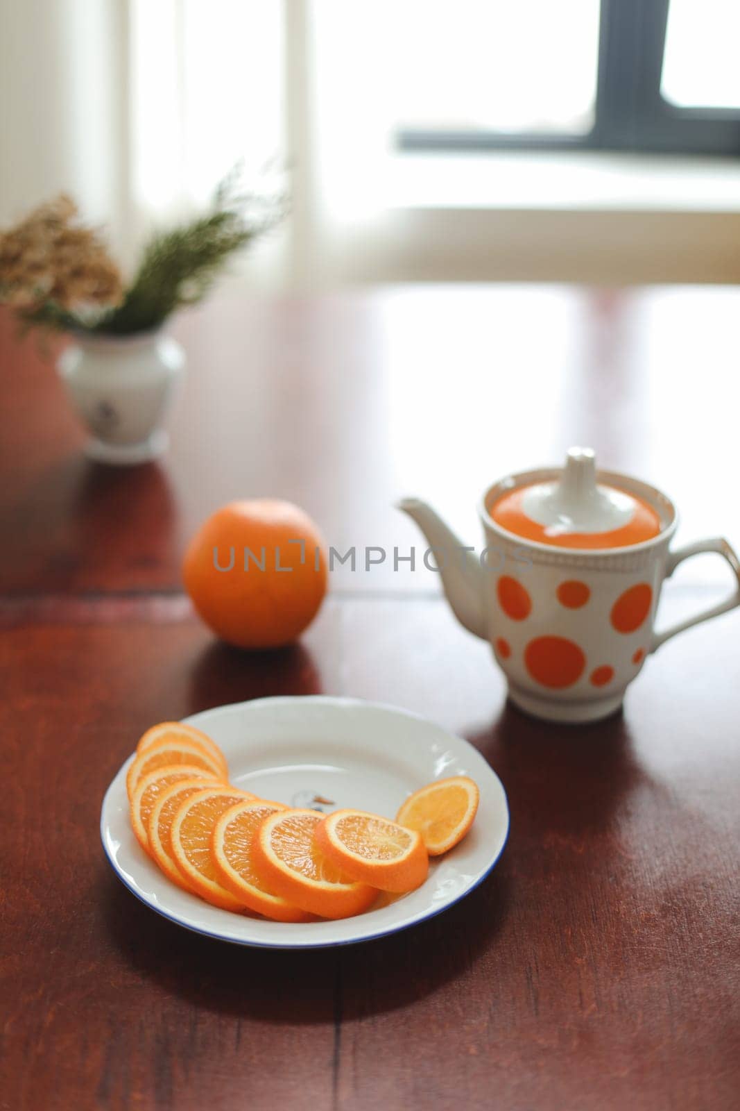 healthy breakfast, drink, orange slices on a plate on wooden table. detox diet concept, summer vitamin drinks